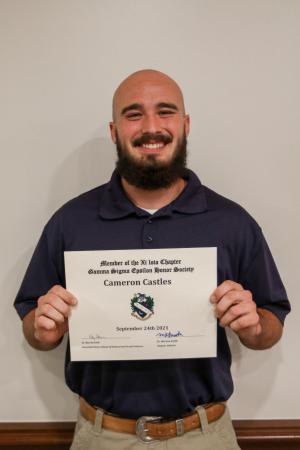 Person holding a certificate and smiling.