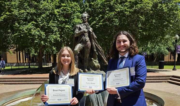 Two students hold awards received at the East Texas Regional Phi Alpha Theta Conference 2024